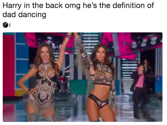 Screen grab with two Victoria Secret models high-fiving each other as Harry Styles dances in the background Screen grab with two Victoria Secret models high-fiving each other as Harry Styles dances in the background